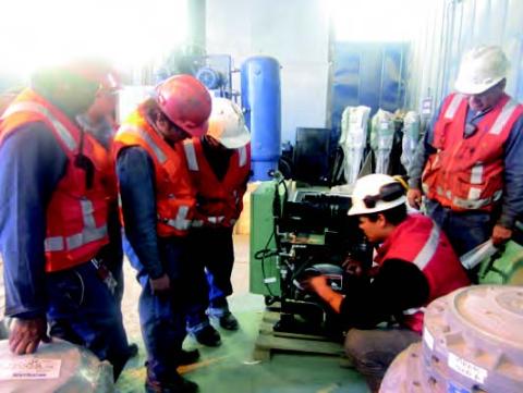 Miners examining a Sullair compressor