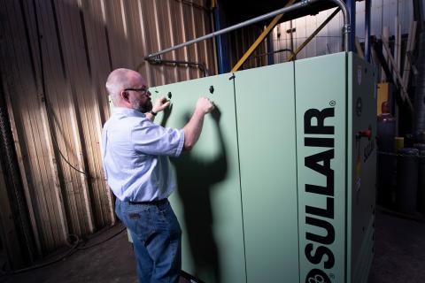 Service technician with Sullair S-energy Series compressor