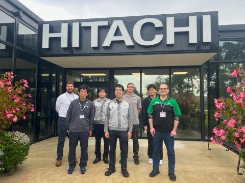 Group of trainees in front of Hitachi building