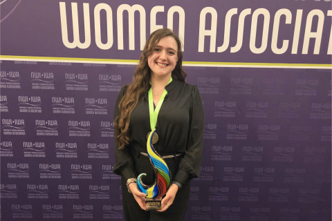 Nicole Pomeroy, Manufacturing Engineer, accepts the 2026 Up & Coming Woman of the Year award. 